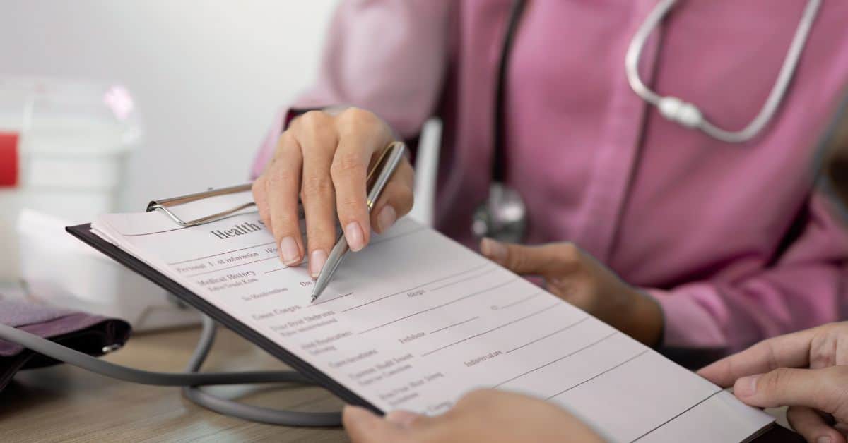 A person is holding a clipboard at a doctor's office.